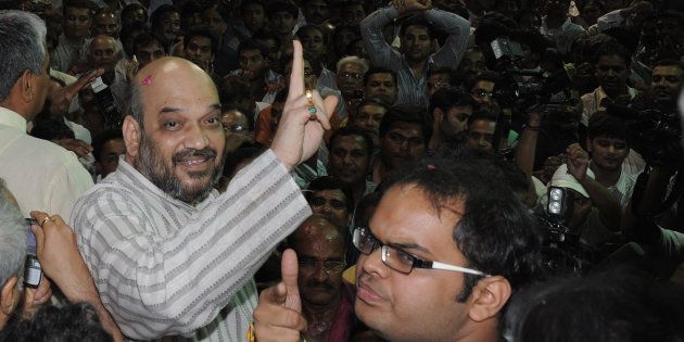 File photo of Indian politician and former Gujarat minister Amit Shah (L) and his son Jay celebrating on his arrival at his residence after his release from Sabarmati Central Jail in Ahmedabad late on October 29, 2010.