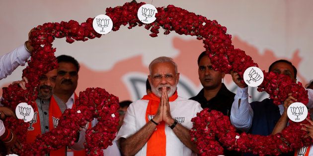 India's Prime Minister Narendra Modi is garlanded by supporters during a public rally at Bhaat village on the outskirts of Ahmedabad, India October 16, 2017. REUTERS/Amit Dave