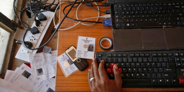 An operator works on his table while enrolling villagers for the Unique Identification (UID) database system at an enrolment centre at Merta district in the desert Indian state of Rajasthan February 21, 2013.