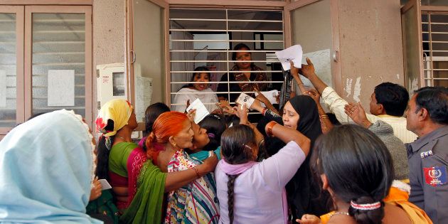 FILE PHOTO: Woman jostle to enrol themselves for Unique Identification (UID) database system in Ahmedabad February 14, 2013.