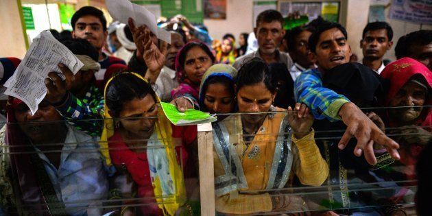 In this photograph taken on November 16, 2016, Indian villagers wait inside the bank to make the transactions in Basendua village in Bulandshahr, in northern Uttar Pradesh state.