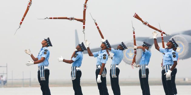 Indian Air Force soldiers toss their rifles as they perform during the full-dress rehearsal for Indian Air Force Day.
