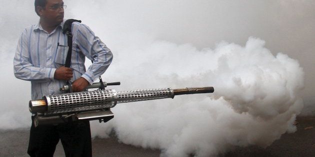 A health worker fumigates a residential area to prevent the spread of dengue fever in Chandigarh, India, September 20, 2015.
