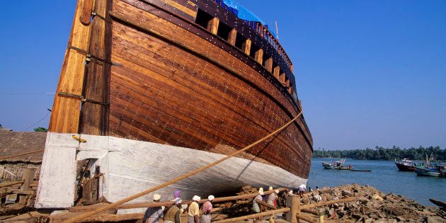 Dhow, a traditional Indian sailing vessel, under construction at the port in Beypore, Kerala.