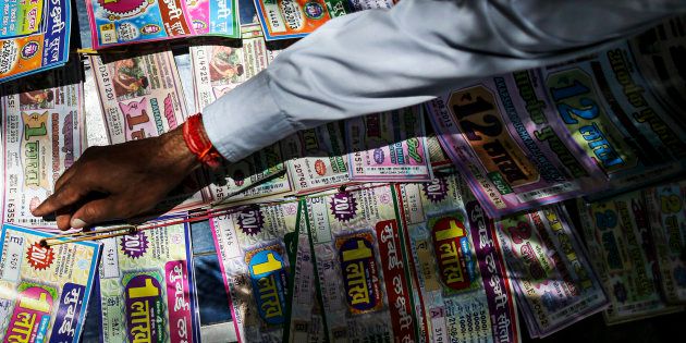 A roadside vendor arranges lottery tickets in Mumbai, India, on Wednesday, Aug. 21, 2013.
