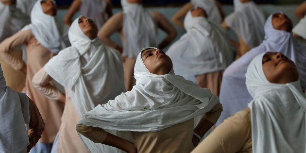 Muslim girls attend a yoga lesson at a school ahead of International Yoga Day in Ahmedabad, India, June 15, 2017. REUTERS/Amit Dave