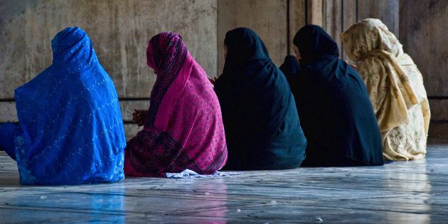 Muslim women in prayer inside Jama Masjid mosque.