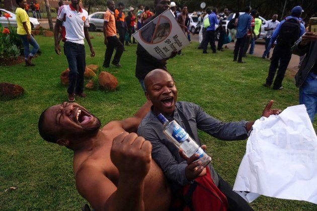 People celebrate in the streets of Harare, after the resignation of Zimbabwe's president Robert Mugabe on November 21, 2017.