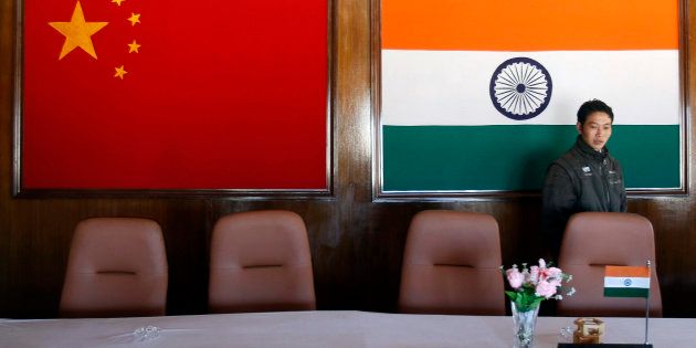 A man walks inside a conference room used for meetings between military commanders of China and India, at the Indian side of the Indo-China border at Bumla, in Arunachal Pradesh, November 11, 2009.