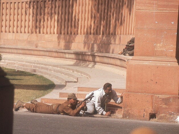 Security personnel take position after the Parliament was attacked in New Delhi, India.