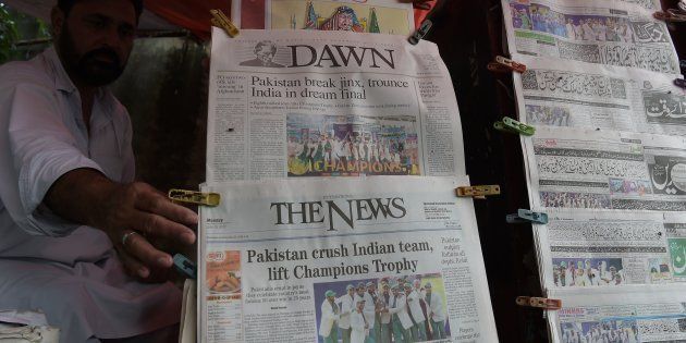 A Pakistani vendor arranges morning newspapers featuring front page coverage of Pakistan's victory against India in the ICC Champions Trophy final cricket match played in London.