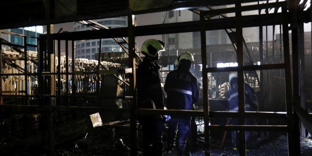 Firemen inspect the debris after a fire at a restaurant in Mumbai, India, December 29, 2017. REUTERS/ Danish Siddiqui