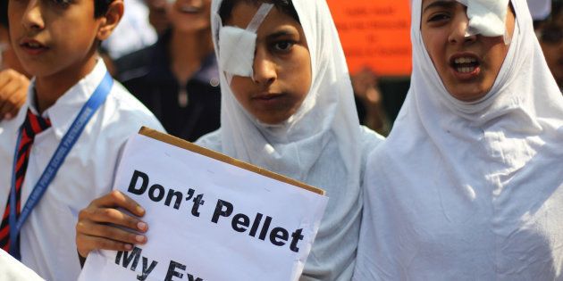 With one eye blind-folded, the students wearing uniform protests conveying 'Dont Pellet My Exams' in Kashmir.