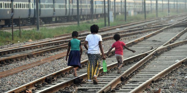 Indian children walk along the railway tracks after defecating in the open on International Toilet Day.