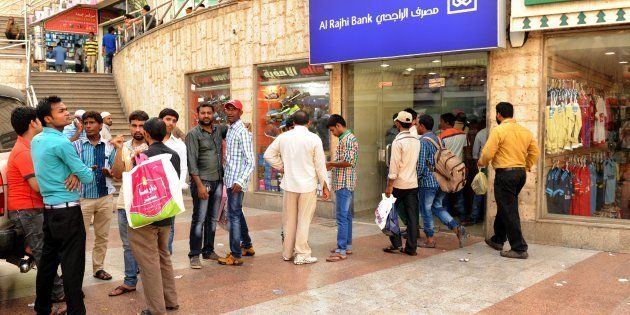Indian workers queue outside a bank branch in the Saudi Arabian port city of Jeddah on August 4, 2016.