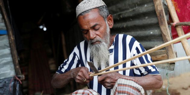Hamid Hussain, a 71-year-old Rohingya refugee cuts firewood after an interview with Reuters at Kutupalong camp, near Cox's Bazar, Bangladesh January 13, 2018. Picture taken January 13, 2018.REUTERS/Tyrone Siu