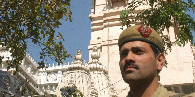 A Policeman guards the entrance of the Chattarpur Temple at Chattarpur Enclave, New Delhi.