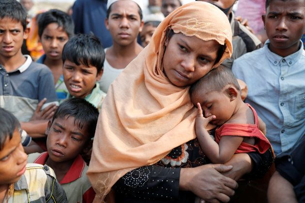 Samjida, the wife of Momtaz Ullah, reacts outside a hospital after her husband was killed at Kutupalong Rohingya refugee camp, near Cox's Bazar, Bangladesh.