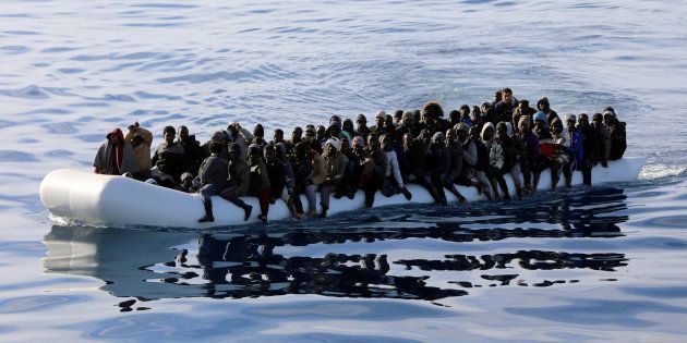 FILE PHOTO: Migrants are seen in a rubber dinghy as they are rescued by Libyan coast guards in the Mediterranean Sea off the coast of Libya, January 15, 2018.