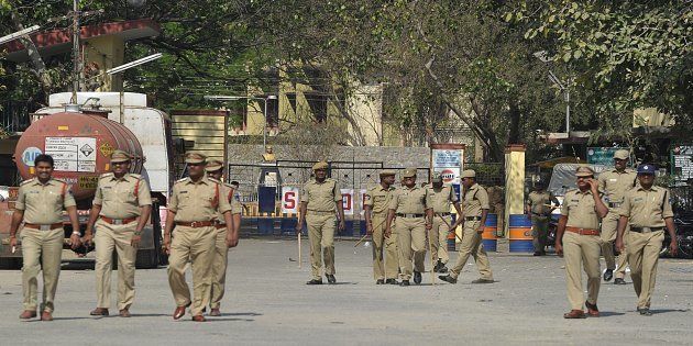 Indian police personnel patrol at the entrance to Gulf Oil Corporation Limited company (Explosives Division) in Hyderabad.