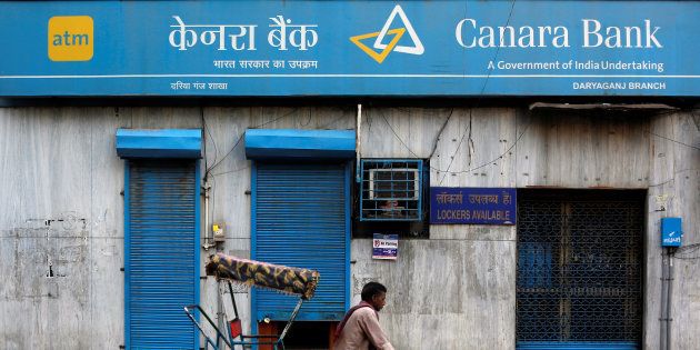 A rickshaw puller passes the Canara Bank branch in the old quarters of Delhi, India, September 6, 2017. REUTERS/Adnan Abidi