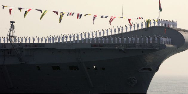 Indian Navy personnel stand on aircraft carrier Viraat, anchored at sea in Visakhapatnam, February 12, 2006.