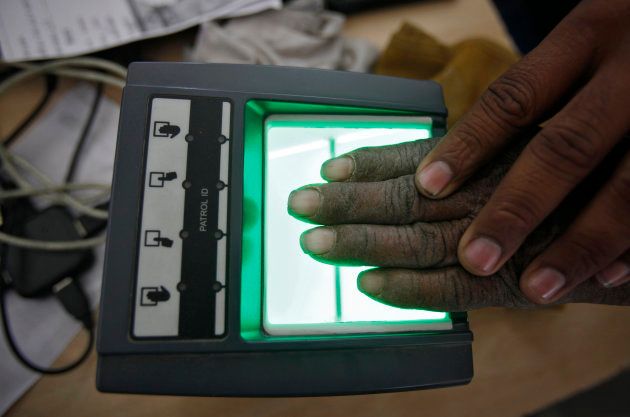 A villager goes through the process of a fingerprint scanner for the Unique Identification (UID) database system at an enrolment centre at Merta district in the desert Indian state of Rajasthan February 22, 2013.