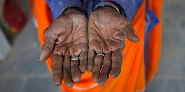 Radha, 75, a vegetable vendor, poses with her hands after she got her fingerprint scanned for the Unique Identification (UID) database system at an enrolment centre at Merta district in the Indian state of Rajasthan on February 22, 2013.