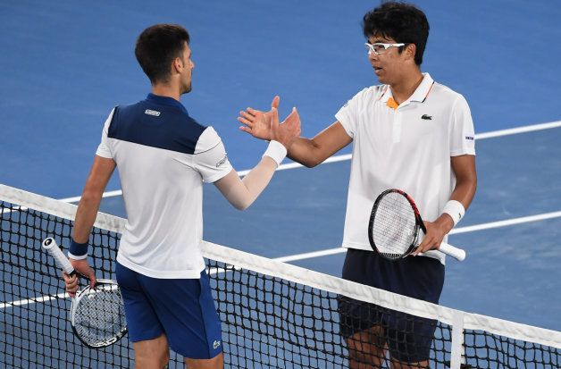 South Korea's Hyeon Chung and Serbia's Novak Djokovic shake hands after their men's singles fourth round match on day eight of the Australian Open tennis tournament in Melbourne on January 22, 2018.