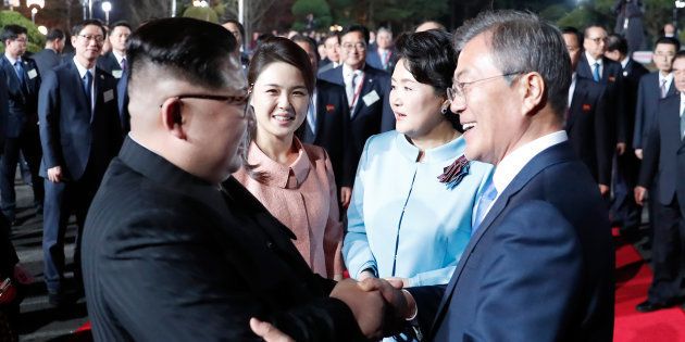 This picture taken on April 27, 2018 shows North Korea's leader Kim Jong Un (L) and South Korea's President Moon Jae-in (R) bidding farewell during a closing ceremony of the inter-Korean summit in the truce village of Panmunjom.