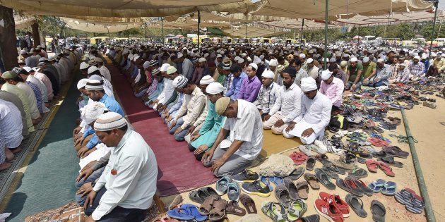 GURUGRAM, INDIA - MAY 11: Muslims offer Namaz at on a ground in Leisure Valley under police protection on May 11, 2018 in Gurugram, India. The mosques were overcrowded and many worshippers arrived late, being unfamiliar with the route, as Gurgaon held Friday namaz in 47 designated places under police protection rather than 100-odd spots as before.
