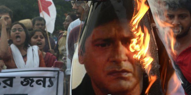 Indian leftist activists burn an effigy of actor and Trinamool Congress MP Tapas Pal in Kolkata on July 5, 2014.