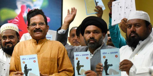 NEW DELHI, INDIA - JUNE 17: Minister of State for AYUSH, Shripad Naik (L) with other Muslims clerics release the book titled 'Yoga and Islam'; the booklet is compiled by the Muslim Rashtriya Manch (MRM), a wing of RSS, at Ayush Bhawan, on June 17, 2015 in New Delhi, India. The book also draws parallels between some yoga exercises and namaaz. (Photo by Vipin Kumar/Hindustan Times via Getty Images)