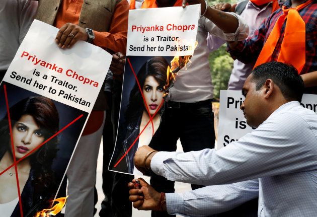 Supporters of Hindu Sena, a right wing Hindu group, burn posters of Priyanka Chopra during a protest on June 9.