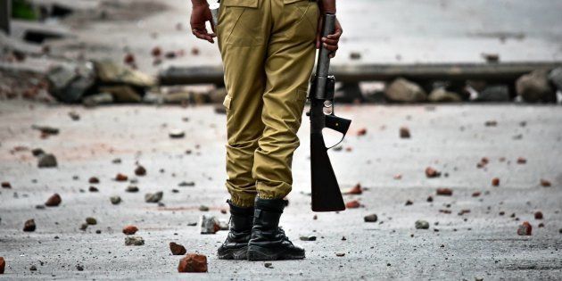SRINAGAR, J&K, INDIA - 2018/05/08: An Indian policeman stands still during clashes in Srinagar, Indian administered Kashmir.