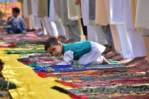 A boy looks on as prayers were offered in Srinagar.