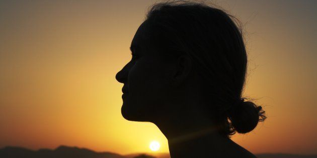 Silhouette of a young woman at sunset. Image used for representational purposes only.