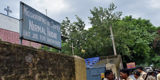Police stand outside a home which provides shelter for pregnant unmarried women run by the Missionaries of Charity, a Roman Catholic order founded by Mother Teresa, in Ranchi.