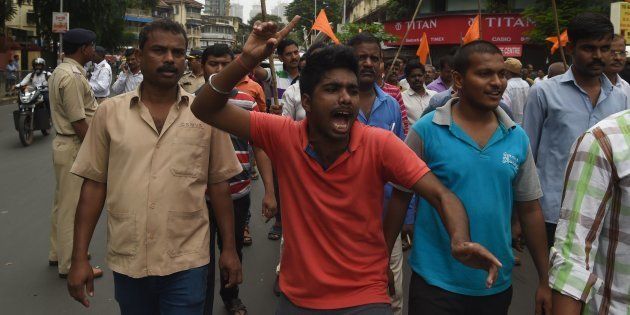 Indian members of the Maratha community in the state of Maharashtra shout slogans during a protest in Mumbai on July 25, 2018.