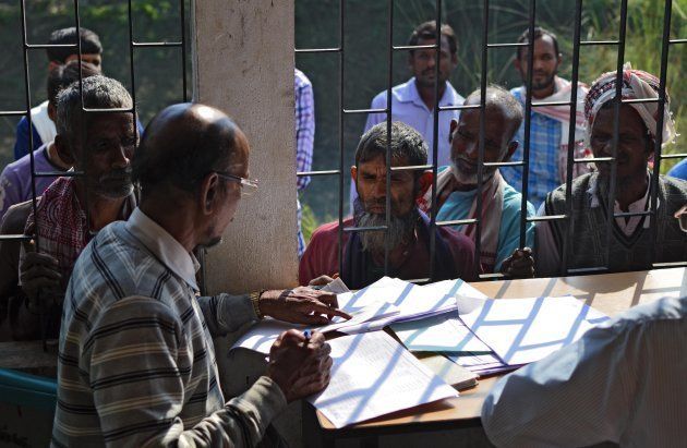 People wait to check their names on the first draft of the National Register of Citizens (NRC) at Goroimari of Kamrup district in the Indian state of Assam on January 1, 2018. Around 13 million people in northeastern India's Assam woke up to uncertainty on January 1 after the release of an official citizenship registry with names of only 19 million of the state's over 32 million residents. The national registry of citizens (NRC) has been in works for years, after strident, decades long demands by many local groups to identify and evict 'illegal foreigners' settling in the state. / AFP PHOTO / Kulendu Kalita (Photo credit should read KULENDU KALITA/AFP/Getty Images)