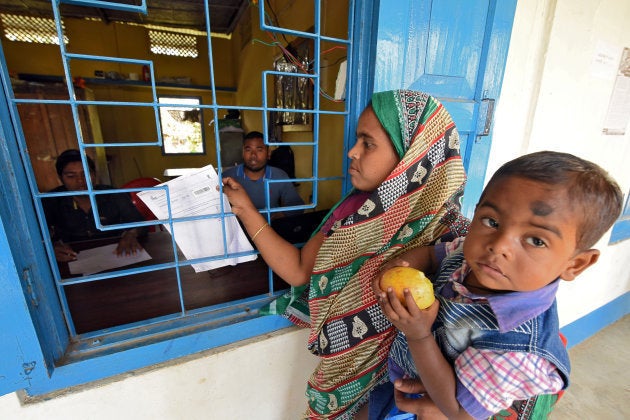 A woman carrying her son arrives to check her name on the draft list of the National Register of Citizens (NRC) at an NRC centre in Chandamari village in Goalpara district in the northeastern state of Assam, India, January 2, 2018. Picture taken January 2, 2018. REUTERS/Anuwar Hazarika