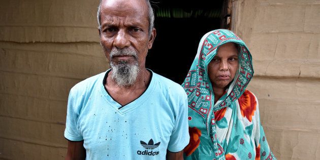 Abdul Suban, a farmer, and his wife pose for a photograph outside their home in Nellie village, in Morigaon district, in the northeastern state of Assam, India July 25, 2018.