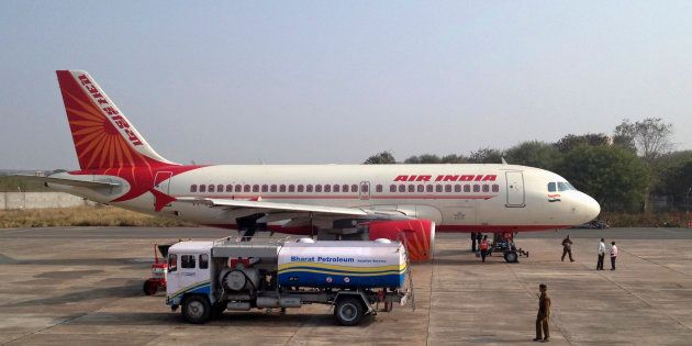 A Bharat Petroleum refuelling vehicle sits on the tarmac next to an Air India A320 aircraft as it refuels the plane with jet fuel in Gwalior February 23, 2012. REUTERS/Vivek Prakash