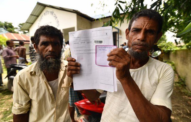 A resident holds documents on his way to check their names on the final list of National Register of Citizens (NRC) at a NRC Sewa Kendra (NSK) in Kuranibori village in Morigoan district on July 30, 2018. - India on July 30 stripped four million people of citizenship in the northeastern state of Assam, under a draft list that has sparked fears of deportation of largely Bengali-speaking Muslims. Critics say it is the latest move by right-wing Prime Minister Narendra Modi to advance the rights of India's Hindu majority at the expense of its many minorities, in particular its over 170 million Muslims. (Photo by Biju BORO / AFP) (Photo credit should read BIJU BORO/AFP/Getty Images)