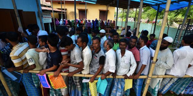 People wait in queue to check their names on the draft list at the National Register of Citizens (NRC) centre at a village in Nagaon district, Assam state, India, July 30, 2018. REUTERS/Stringer
