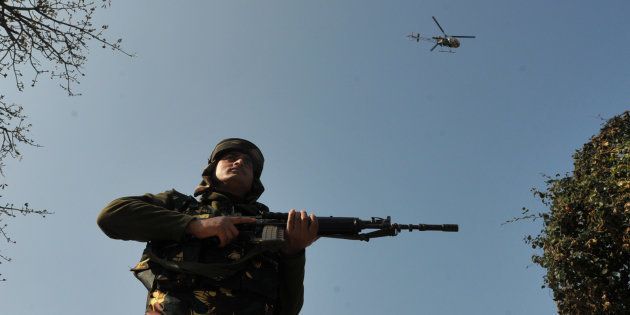 A army helicopter hovering over the sky during a search operation outside the camp of the General Engineering Reserve Force (GREF), the site of a militant attack, on January 9, 2017 in the frontier Battle area, about 105 kilometers from Jammu, India.