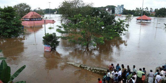 Indian residents look at the Shiva Temple submerged after the release of water from Idamalayar dam following heavy rains in Kochi on August 9, 2018.