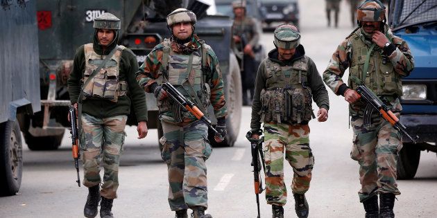 Indian army soldiers patrol a street near a site of a gunbattle between Indian security forces and suspected militants in Khudwani village of South Kashmir's Kulgam district, April 11, 2018. REUTERS/Danish Ismail