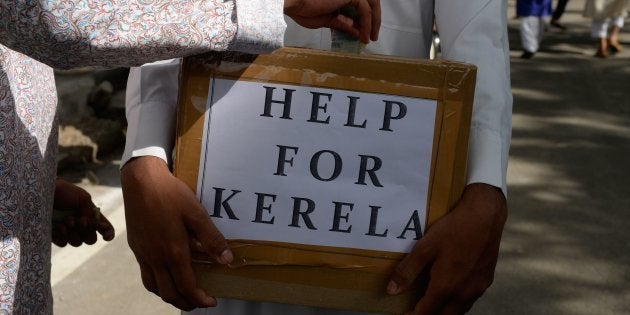 Muslims offer alms to help victims of the Kerala floods after offering Eid al-Adha prayers in Hyderabad on Wednesday.