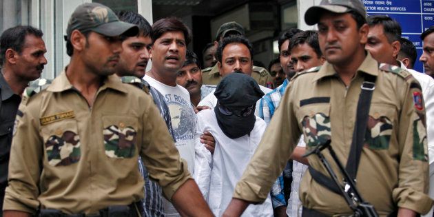 Sayeed Zabiuddin Ansari, also known as Abu Jundal, with his face covered, leaves from a hospital in New Delhi June 29, 2012.